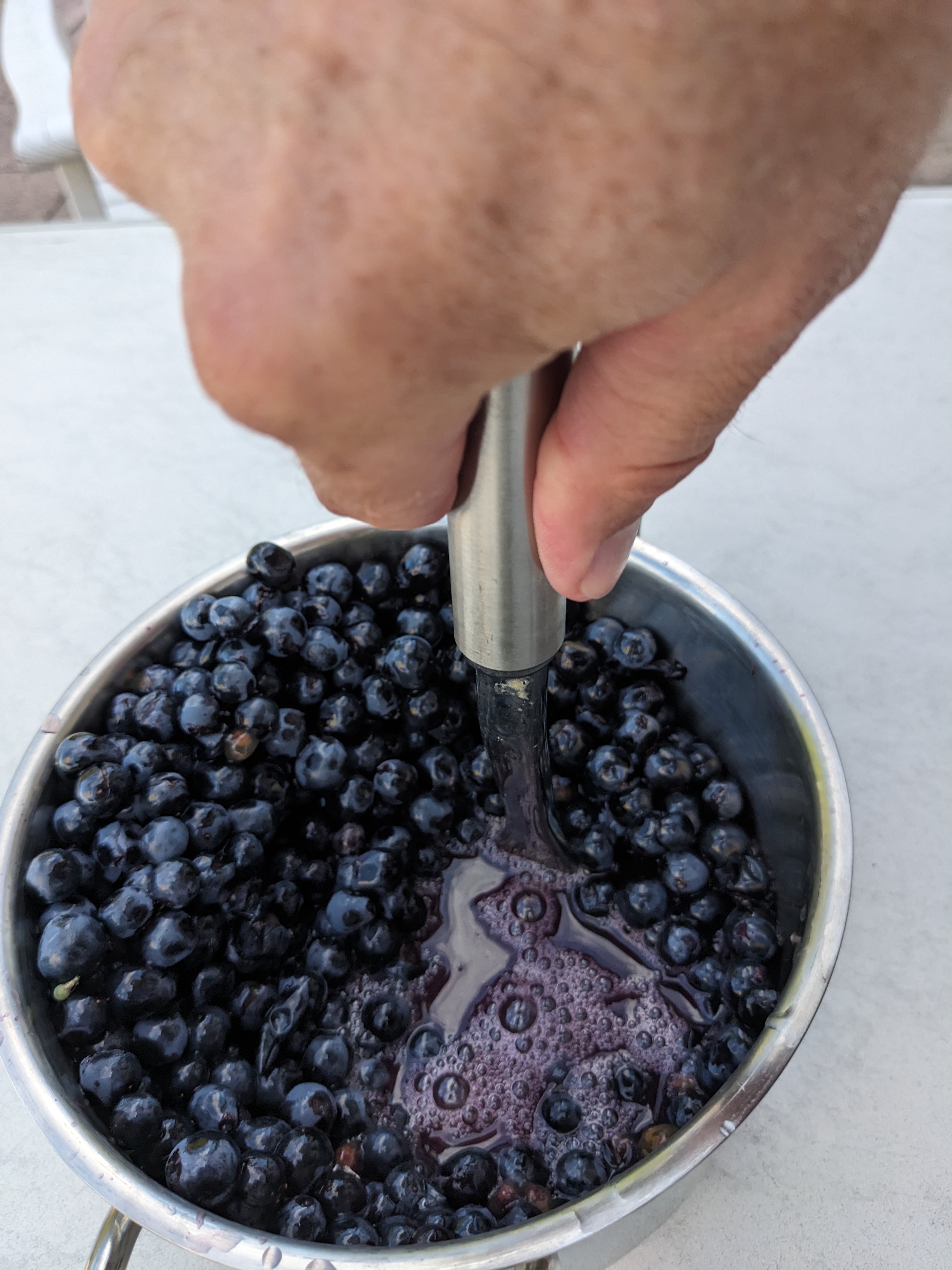 The potato masher pushed deeply into the grapes. The expressed juice makes it look like an extremely poor attempt at braising them.