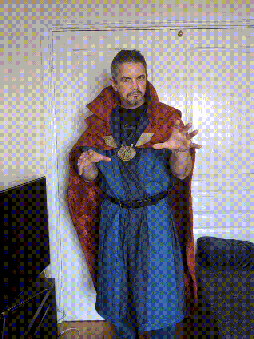 Animated GIF of me in costume, moving from a hands-outstretched spell-casting position to giving two thumbs up and a silly grin